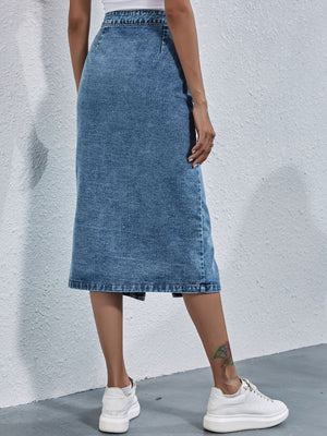 Button-front denim midi skirt in light wash with pleats.