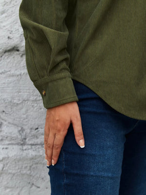 Olive green corduroy button-up shirt with a single button cuff detail.