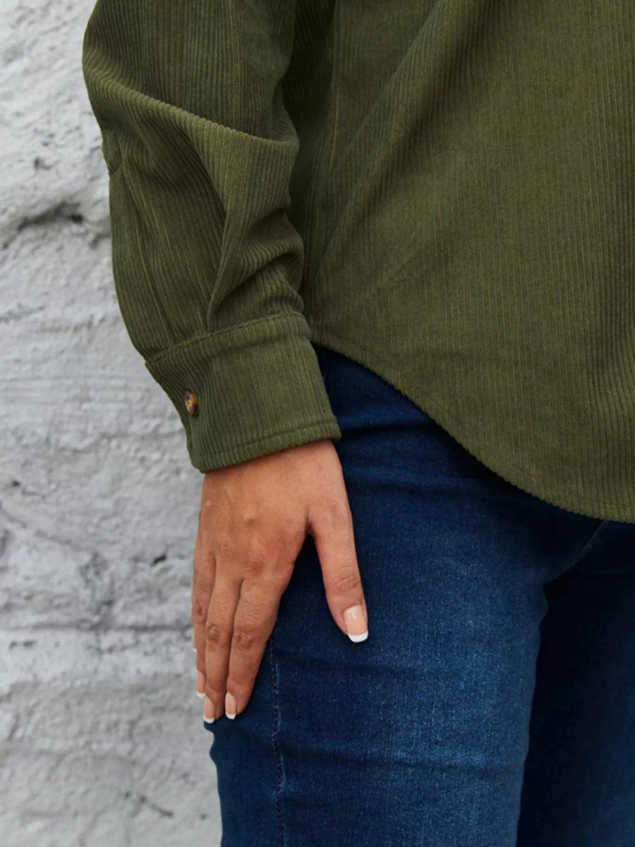 Olive green corduroy button-up shirt with a single button cuff detail.