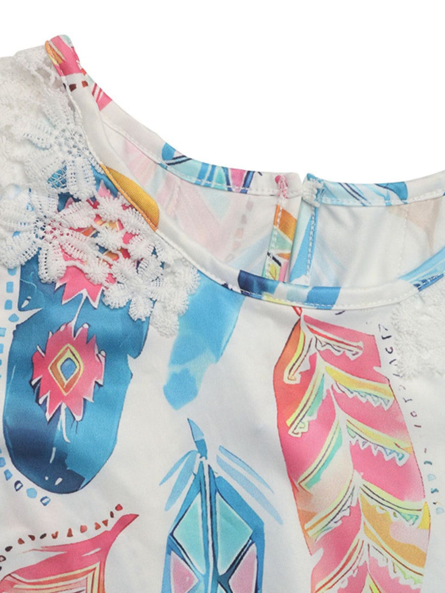 White feather print blouse with crochet trim at the neckline and sleeves.