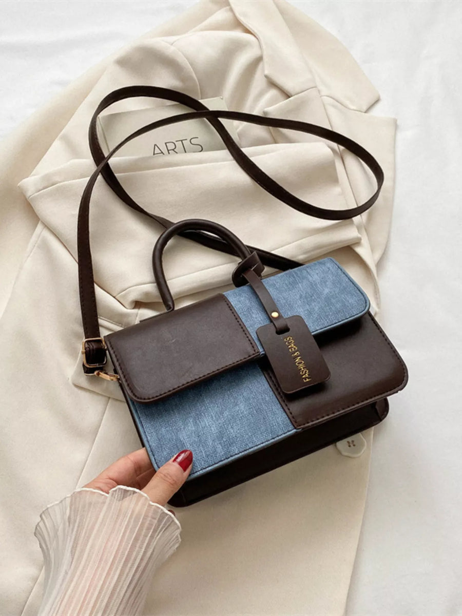 Chic two-tone PU leather crossbody bag with brown and denim blue panels.