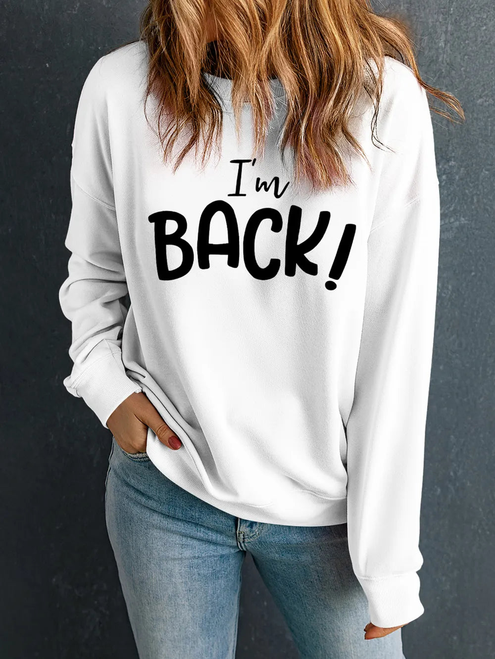 White crewneck sweatshirt with black "I'm BACK!" graphic print.