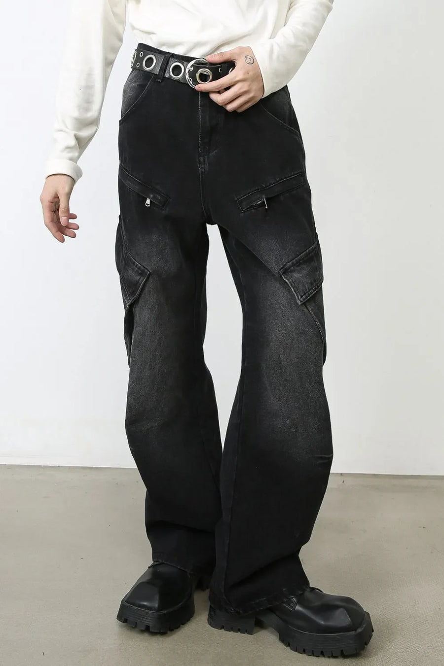 Faded black denim utility cargo pants with multiple zip pockets and a wide leg.