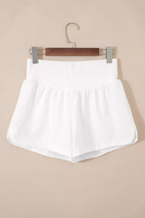 White relaxed fit shorts with a ribbed high-rise waist and dolphin hem.