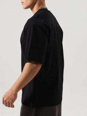 Black washed cotton t-shirt with a boxy cut and short sleeves.