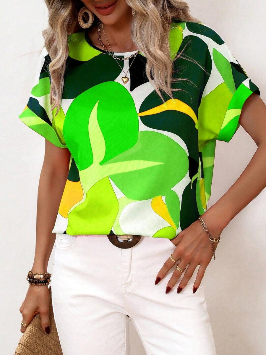 Women's abstract floral print tee in green, yellow, and white with short sleeves and a round neckline.