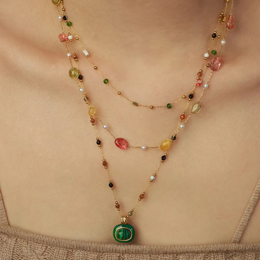 Gemstone Cascade Layered Necklace with green pendant and colorful beads on gold chains