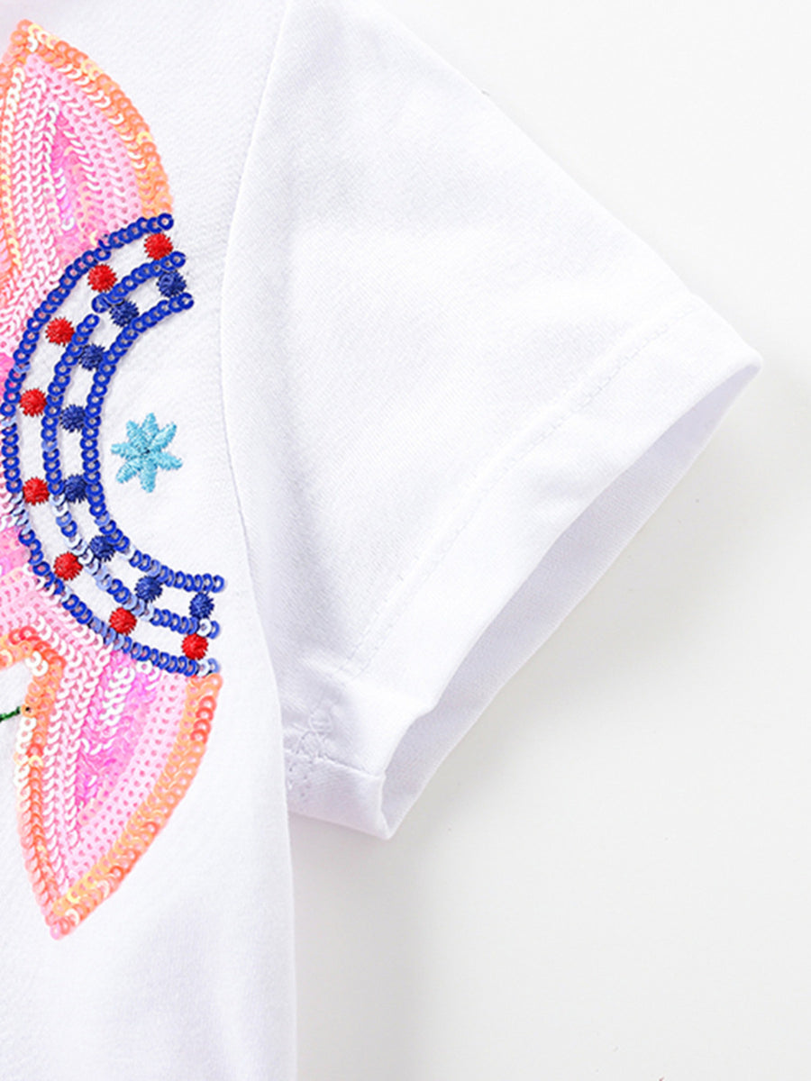 White toddler dress with sequin flower applique and embroidered details.