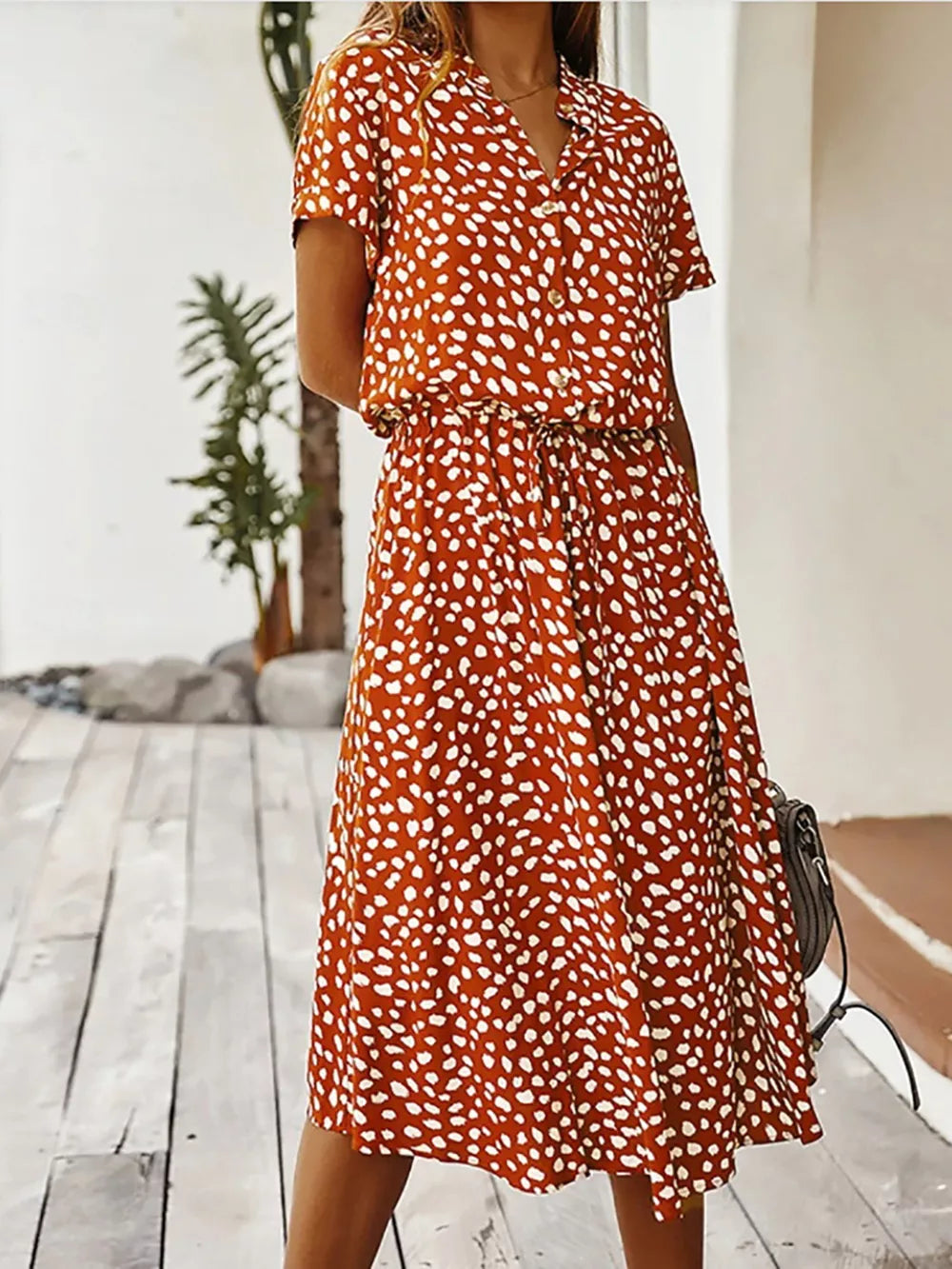 Scarlet polka dot midi dress with drawstring waist and pockets.