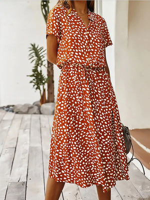 Scarlet polka dot midi dress with drawstring waist and pockets.