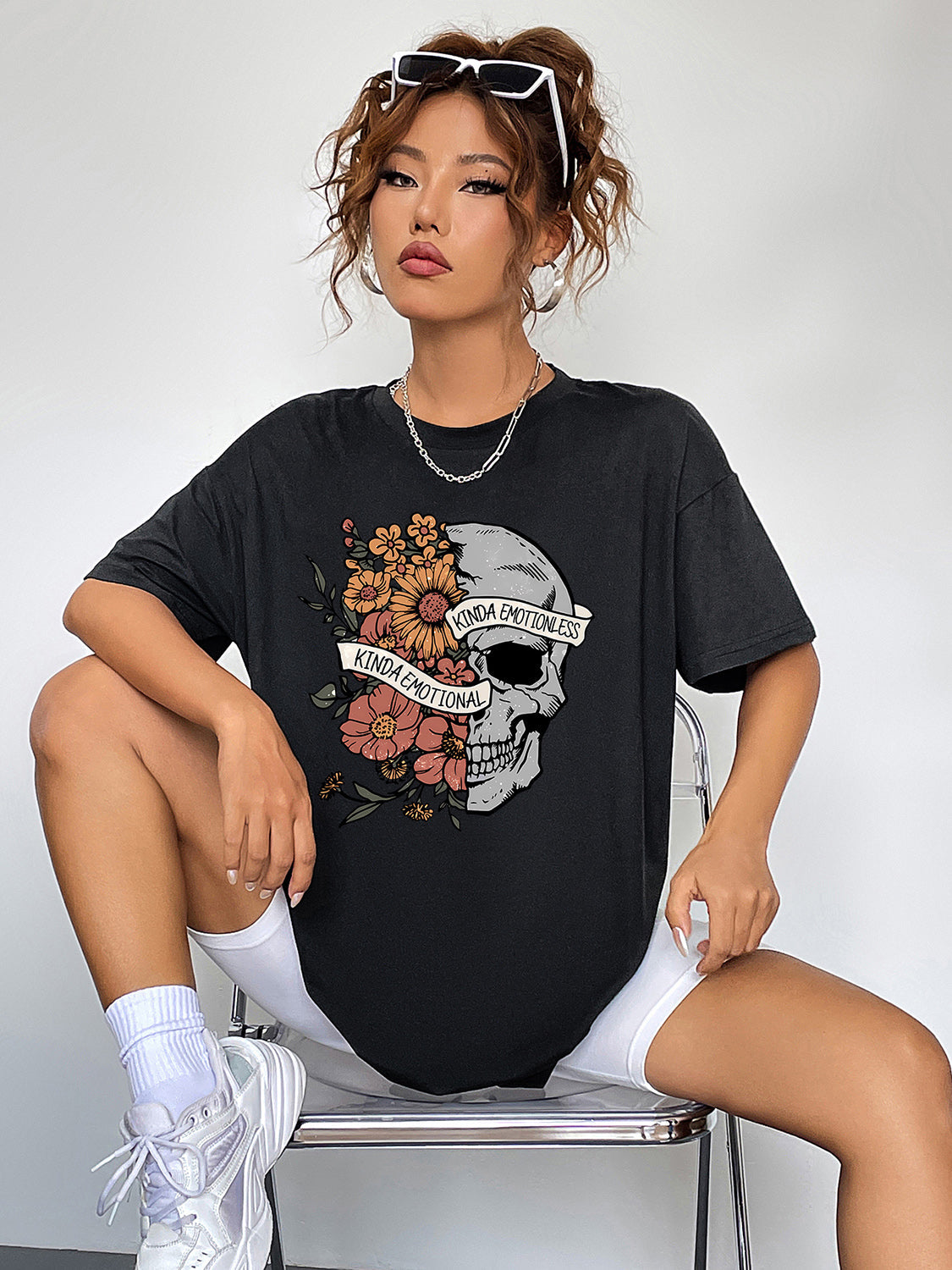 Black oversized tee with skull and floral graphic, "Kinda Emotional" text