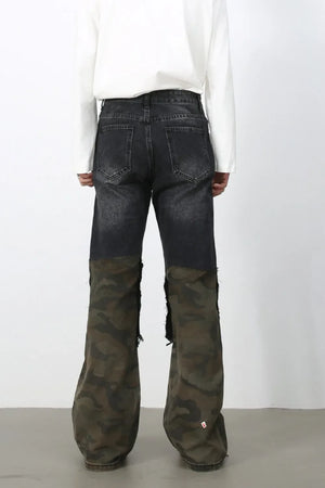 Distressed dark wash flare jeans with camo panel legs and raw hems.