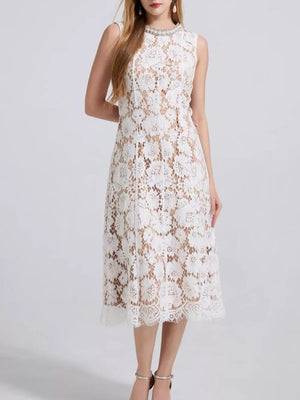 White lace dress with floral pattern and embellished neckline, sleeveless, midi length.