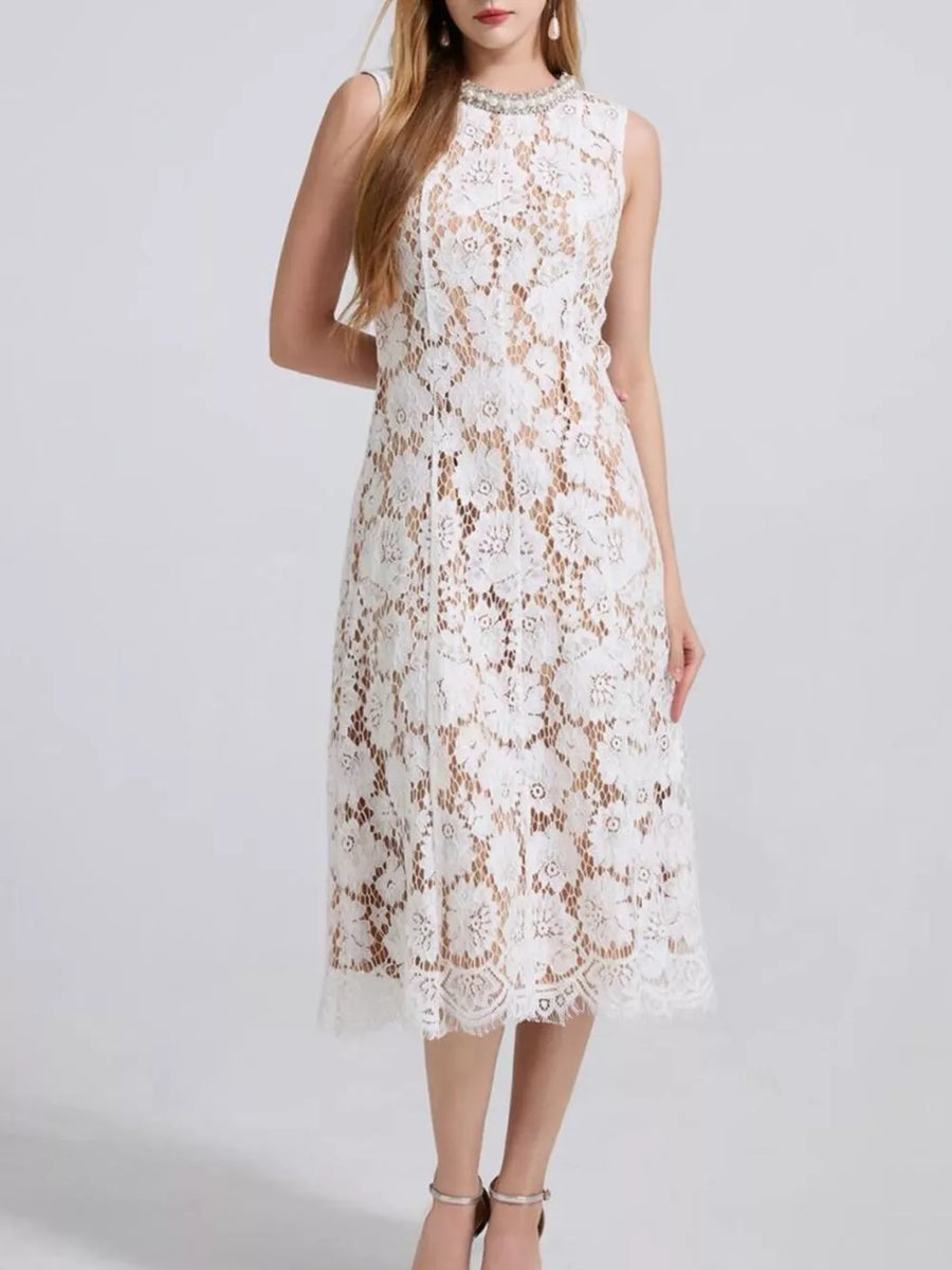 White lace dress with floral pattern and embellished neckline, sleeveless, midi length.