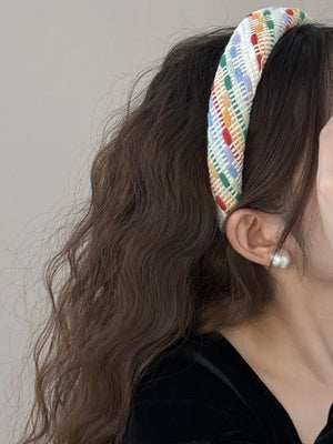 Woven plaid padded headband with multicolor stripes and a textured weave.