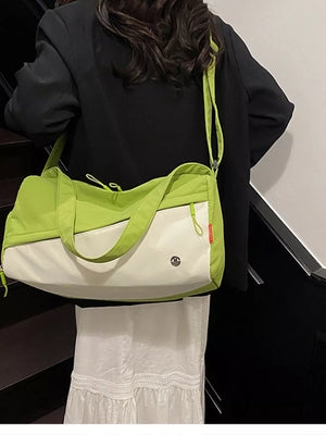 Vibrant color-block nylon travel bag with white and lime green panels and a crossbody strap.