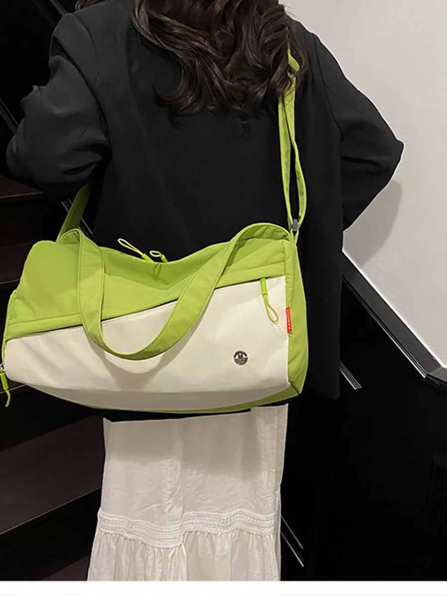 Vibrant color-block nylon travel bag with white and lime green panels and a crossbody strap.