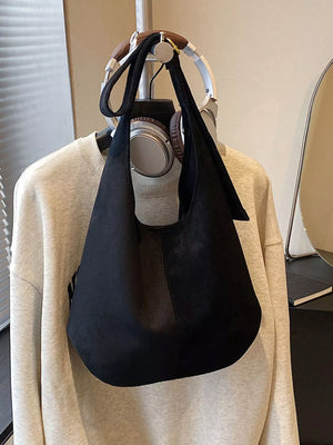 Large black suede hobo shoulder bag with a slouchy silhouette.