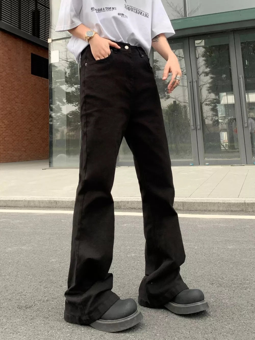 Men's black high-waisted flare leg trousers with a casual streetwear style.