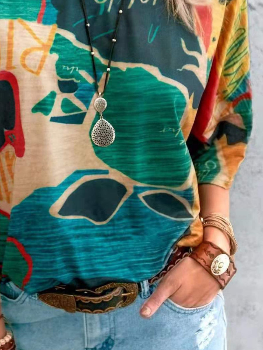 Casual t-shirt with brushstroke geometric print in yellow, green, and blue.