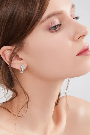 Silver pavé and solitaire hoop earrings with a single large stone and a band of smaller stones.
