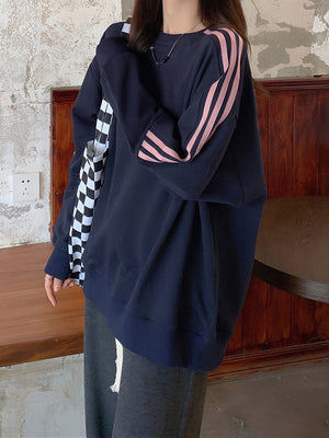 pink sweatshirt featuring ribbed cuffs and striped