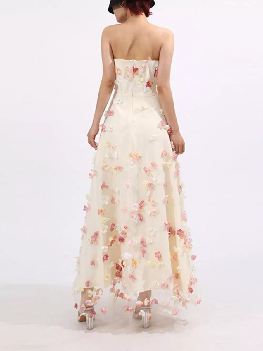 Strapless ivory tulle maxi dress with floral appliques, sweetheart neckline, A-line skirt.