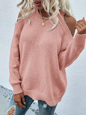 Pink cold shoulder knit sweater with crew neck and ribbed cuffs and hem.