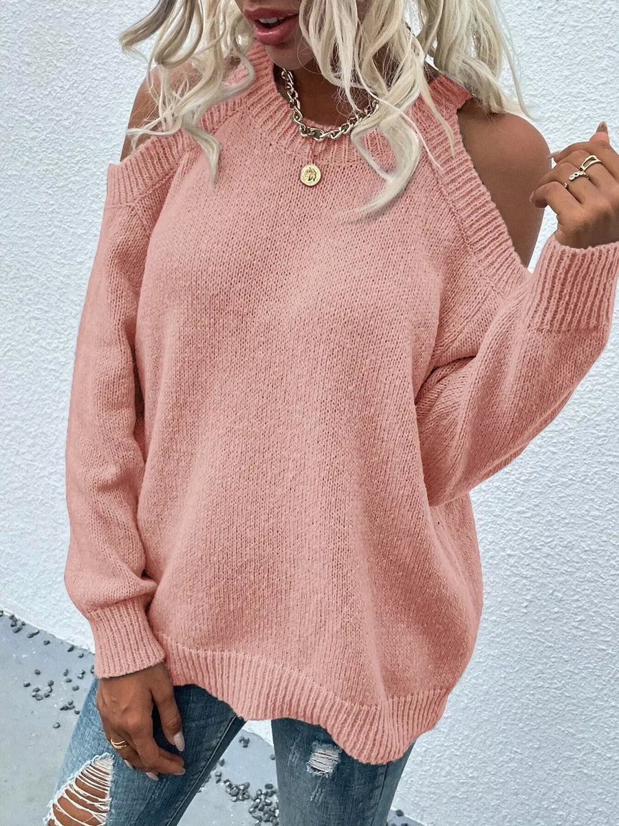 Pink cold shoulder knit sweater with crew neck and ribbed cuffs and hem.