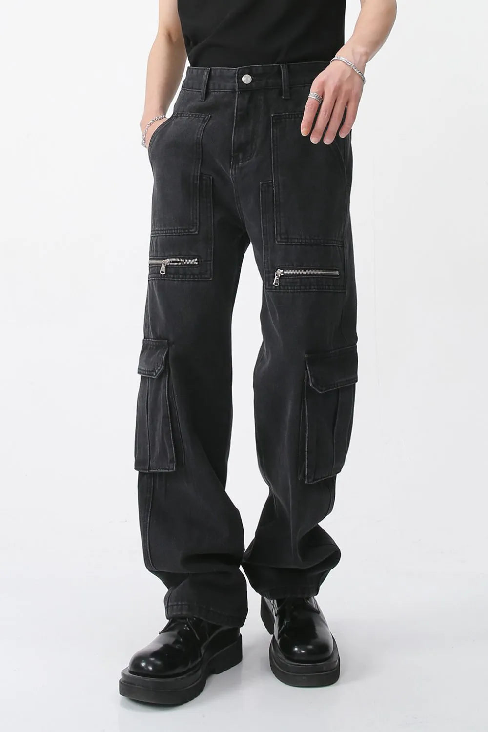 Dark denim wide-leg cargo pants with zip pockets and utility pockets.
