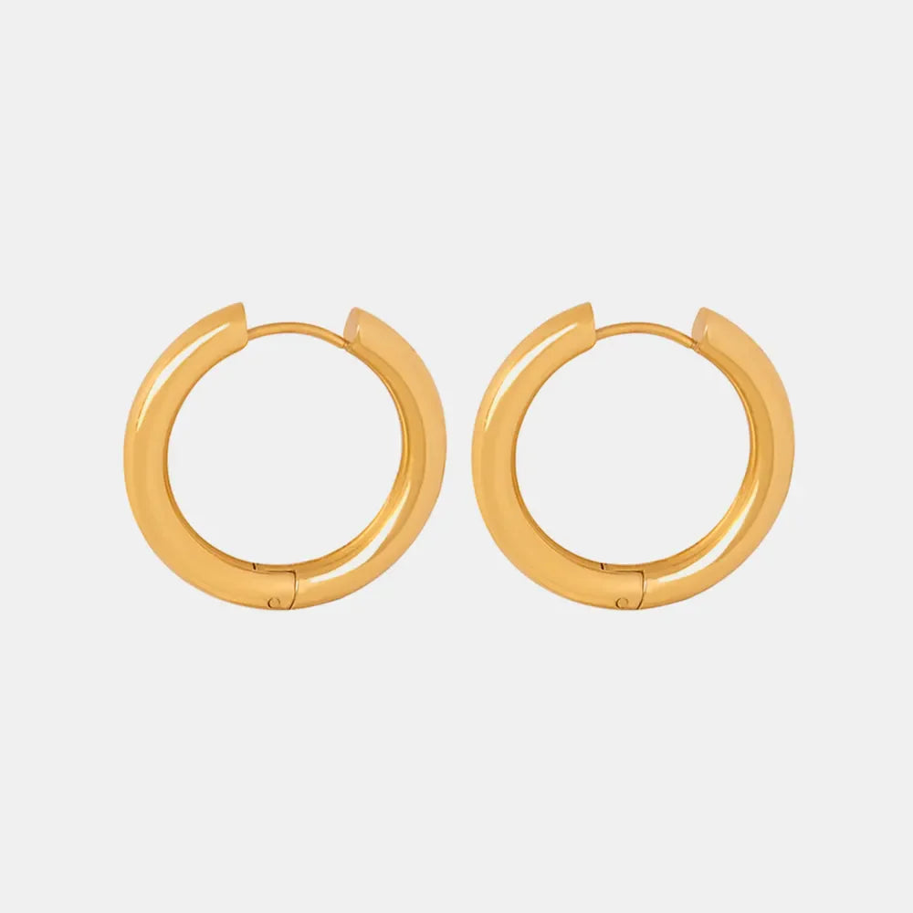 Gold hoop earrings with a sculpted, polished finish.