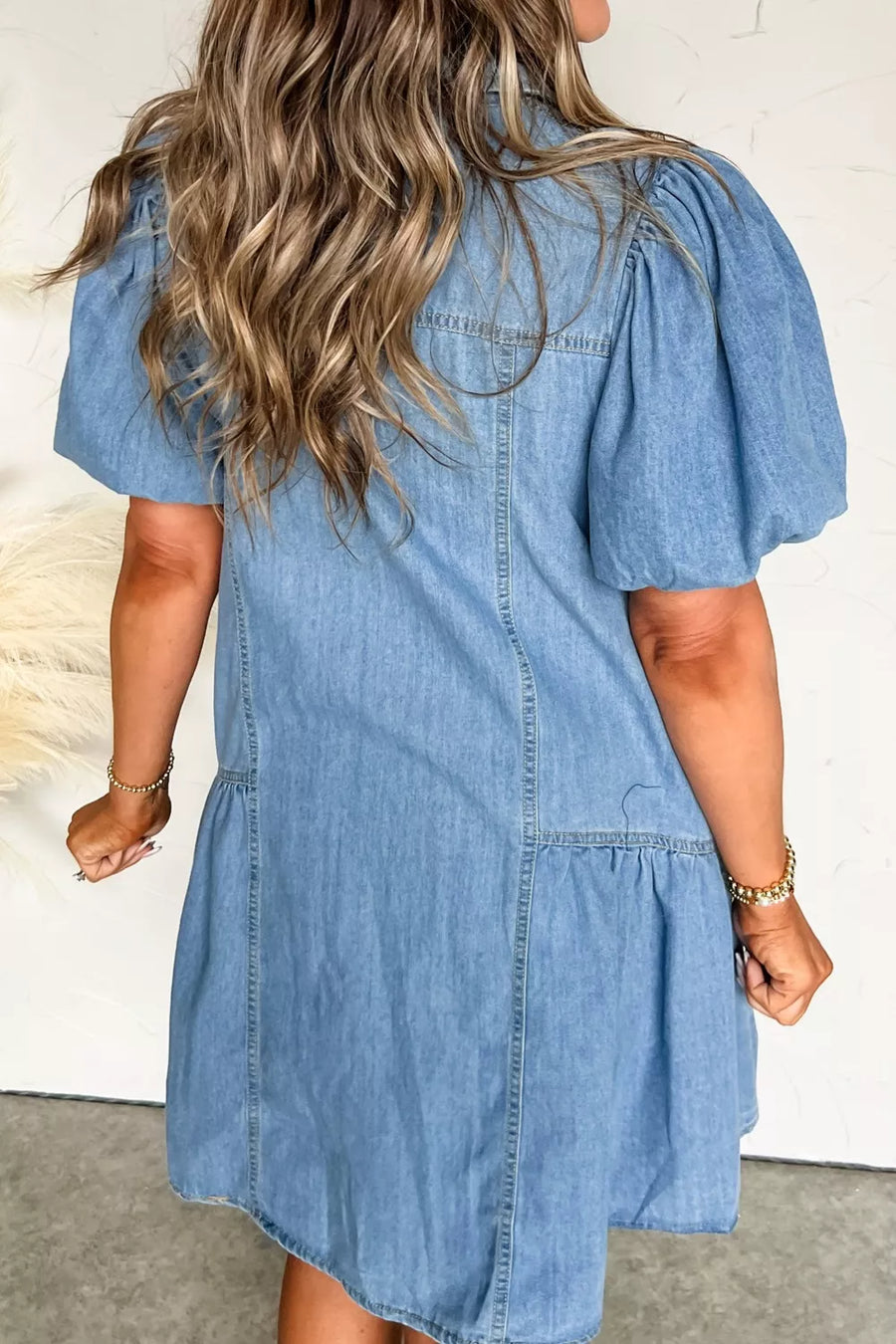 Denim dress with puff sleeves and ruffled hem, button-down style