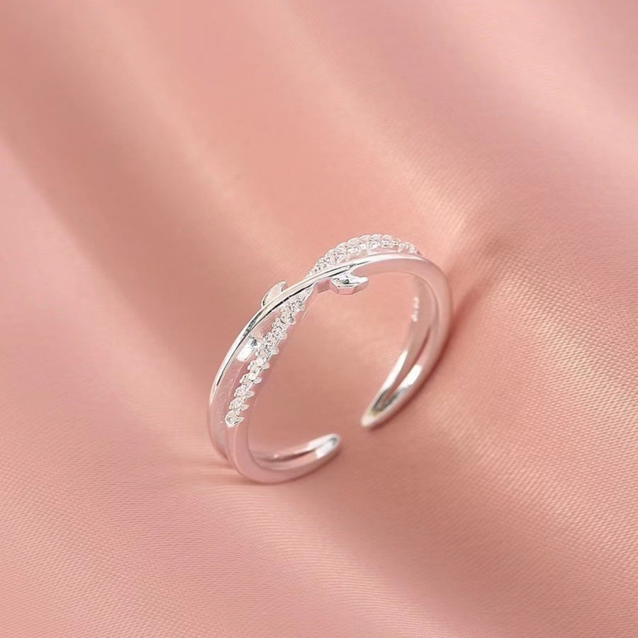 Sterling silver crossover ring with delicate pave crystal detail.