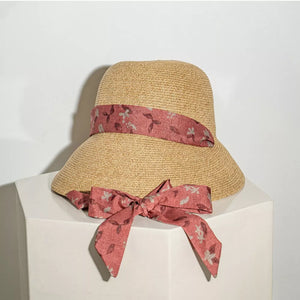 Straw sun hat with red floral ribbon and bow detail