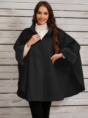 Black cape coat with faux fur trim on collar and cuffs.