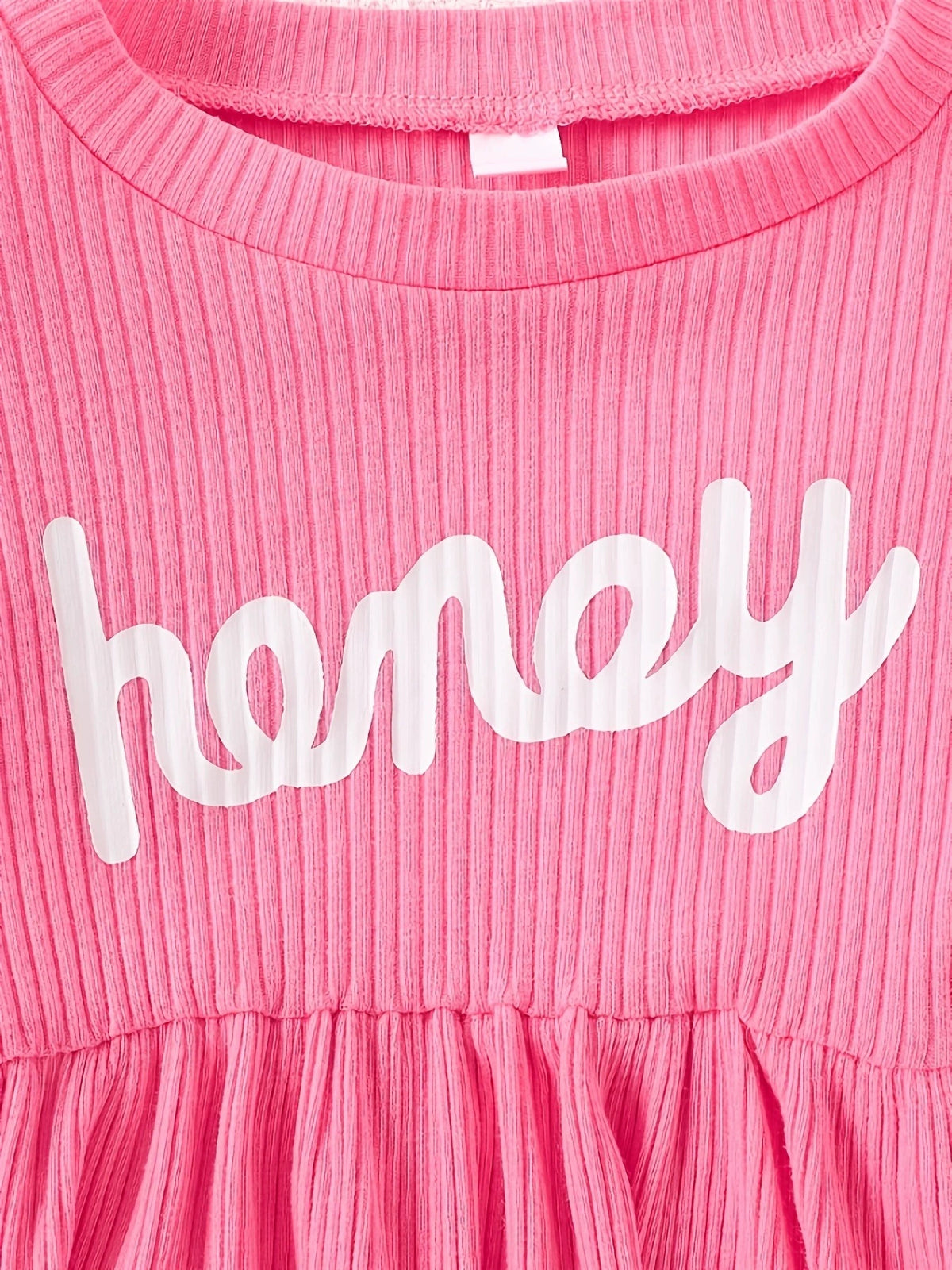 Pink ribbed baby dress with white "honey" graphic and gathered skirt