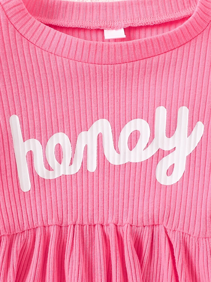Pink ribbed baby dress with white "honey" graphic and gathered skirt