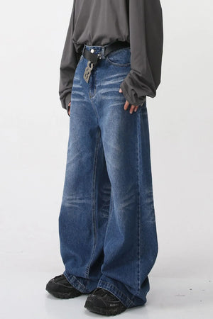 Wide-leg distressed denim jeans in medium blue with a relaxed fit.