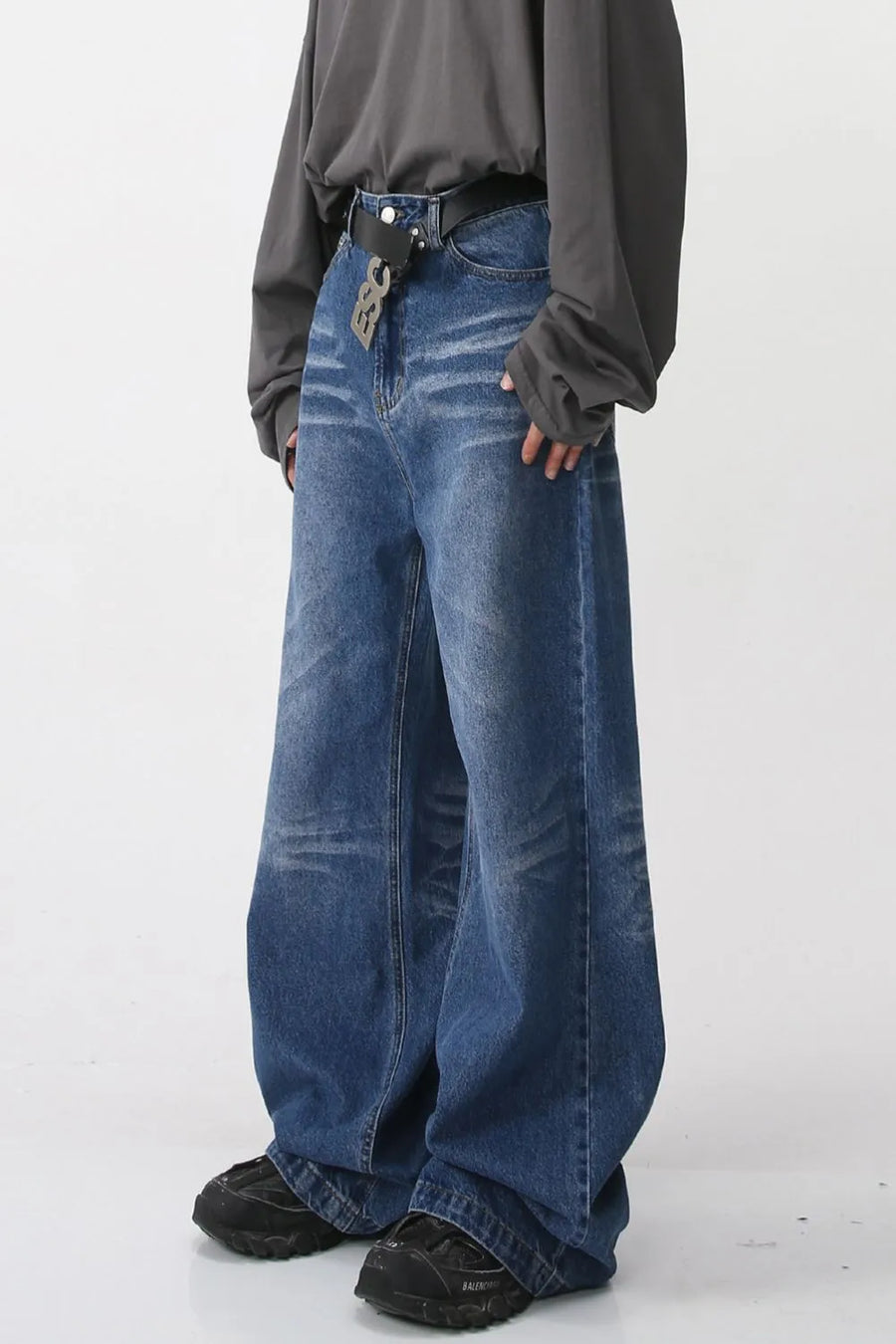 Wide-leg distressed denim jeans in medium blue with a relaxed fit.