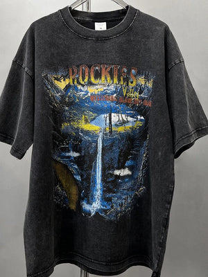 Black vintage wash graphic tee with Rockies mountain and waterfall scene.