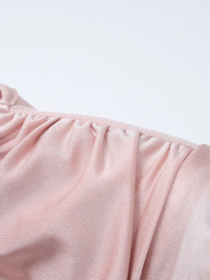 Pink ruched knot front maxi dress detail showing gathered neckline and textured fabric.