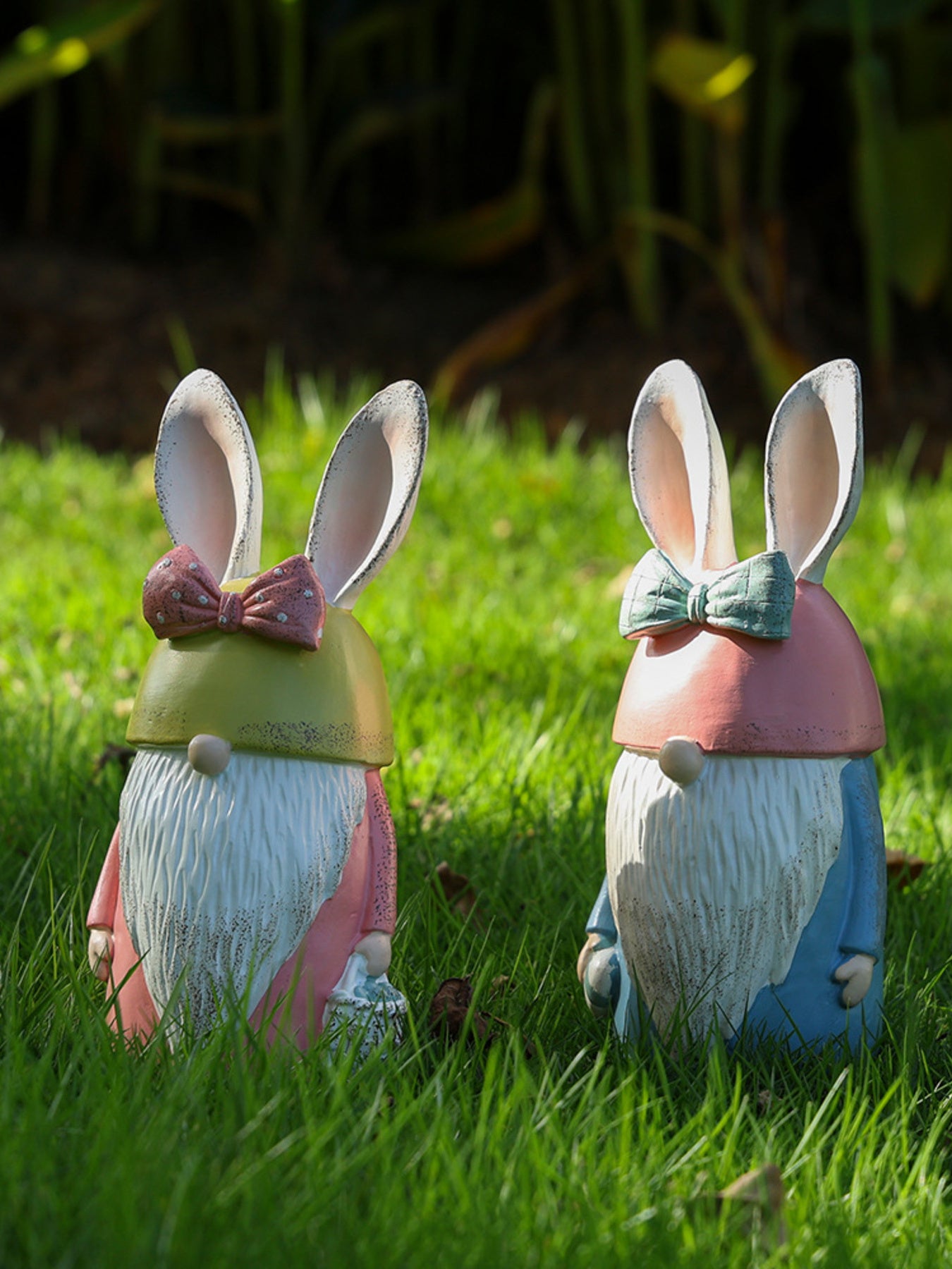 Easter Bunny gnome figures in pastel blue and blush pink with bow ties in grass.