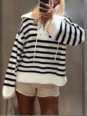 Black and white striped long-sleeve sweater with lace-up neckline and collar.