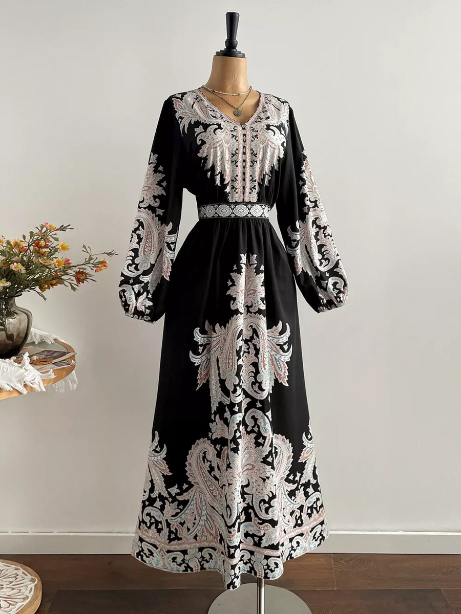 Black maxi dress with V-neck, balloon sleeves, and ornate paisley print.