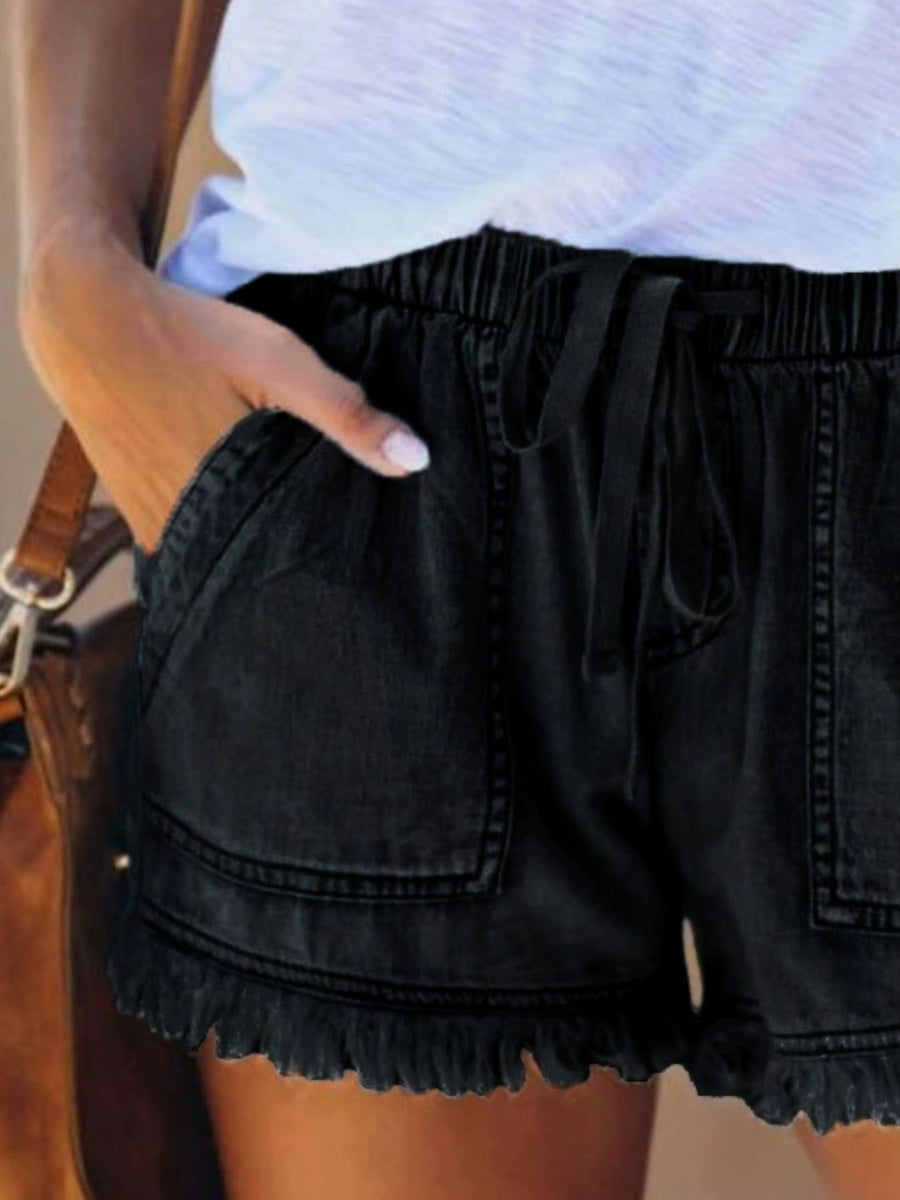 denim shorts in Black with raw hem and mini