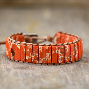 Jasper wrap bracelet with orange marbled stones and leather cord.