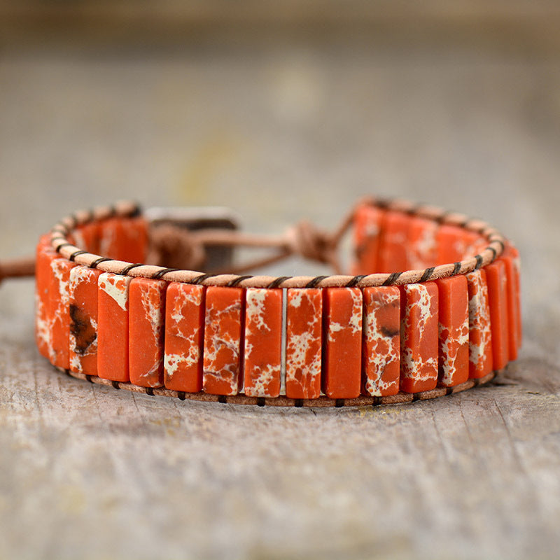 Jasper wrap bracelet with orange marbled stones and leather cord.