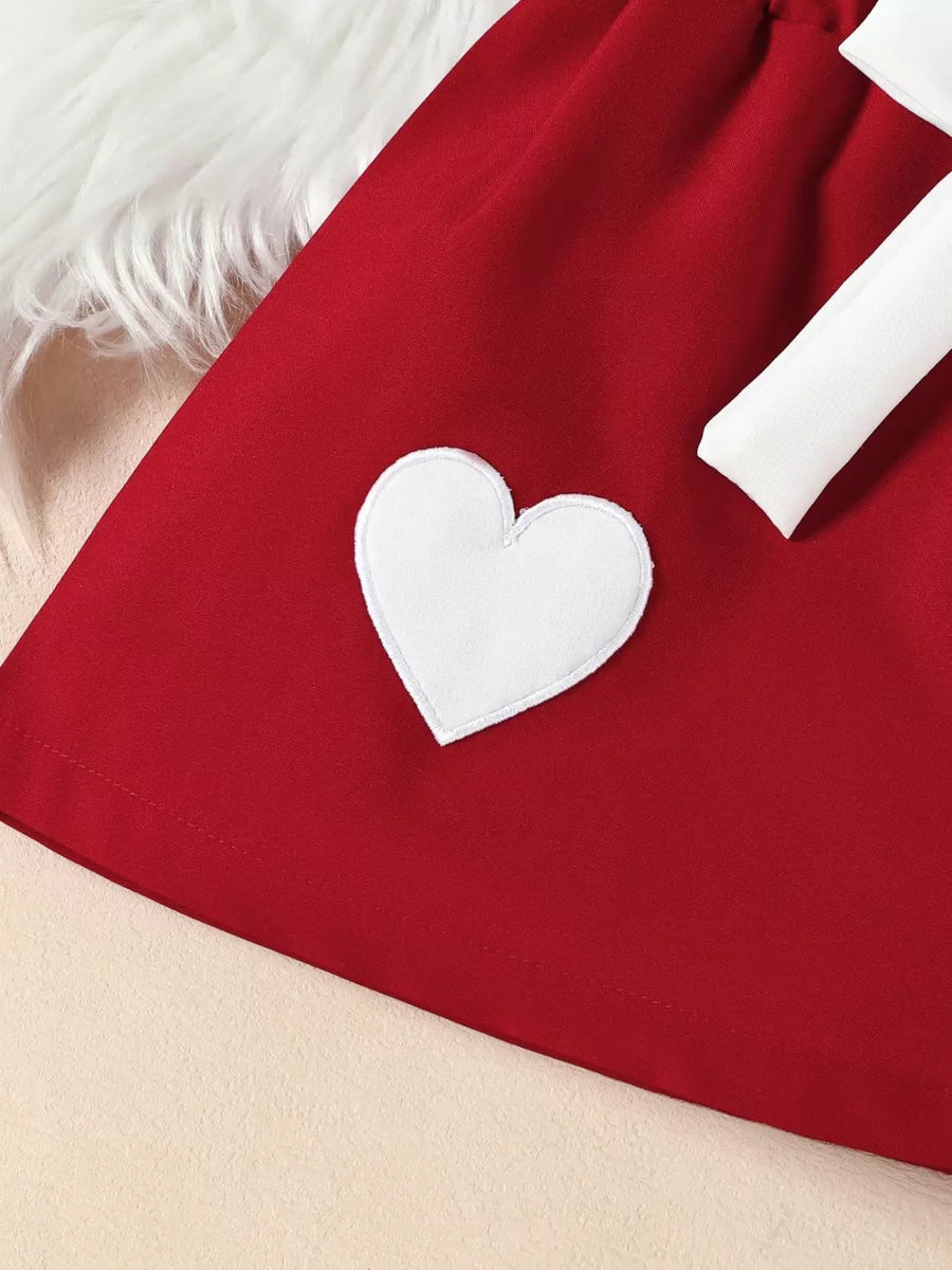 Red baby outfit with white heart applique and bow detail