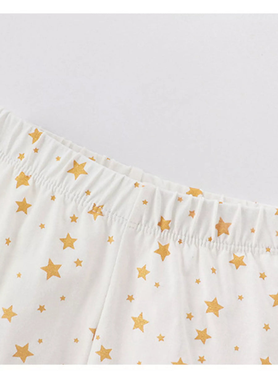 White cotton pajama pants with gold stars and elastic waistband