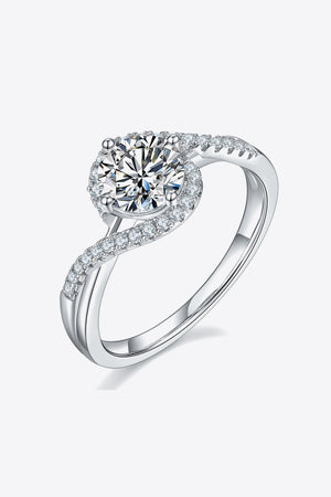 Silver swirl halo moissanite engagement ring with pave diamond band.